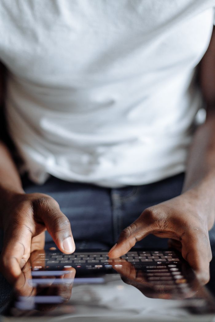 Hands of a person using a digital tablet indoors, highlighting modern technology lifestyle.